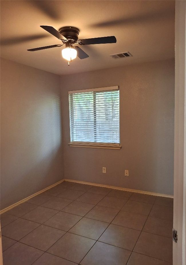 Bedroom featuring light tile patterned flooring, ceiling fan, and baseboards | Image 14