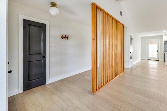 Entryway with baseboards, visible vents, and light wood finished floors | Image 8
