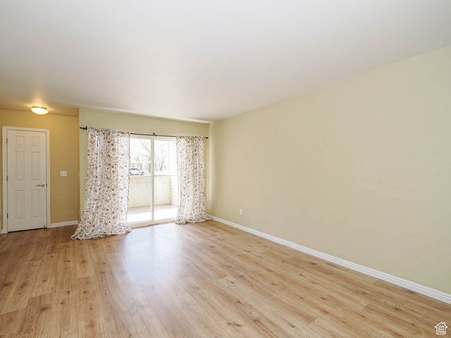 Unfurnished room with light wood-type flooring and baseboards | Image 5