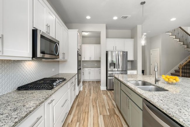 Kitchen featuring a built in double oven, and white cabinetry | Image 8