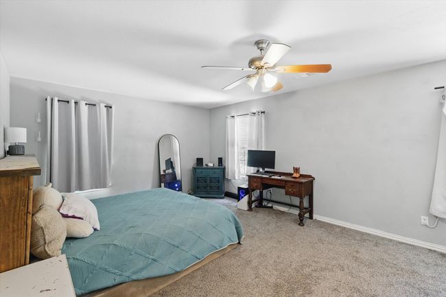 Carpeted bedroom featuring a ceiling fan and baseboards | Image 15