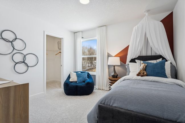 Photo is of the actual model. One of three generously sized upper level secondary bedrooms with spacious closets. | Image 26