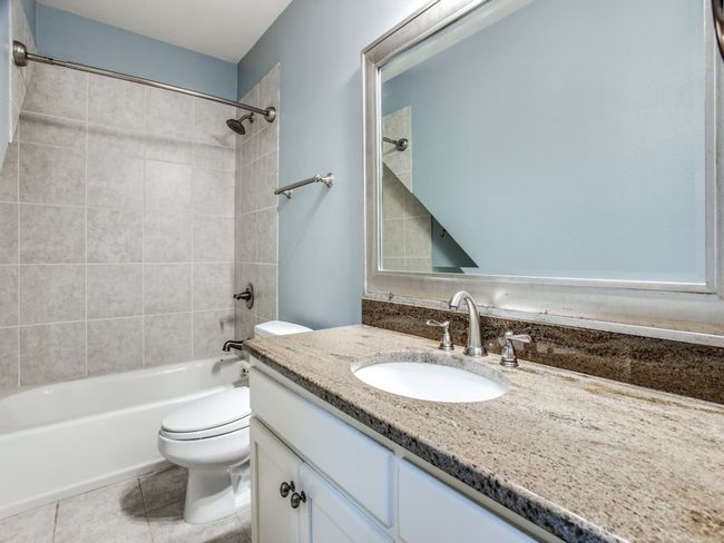 Bathroom featuring shower / bathing tub combination, toilet, vanity, and tile patterned flooring | Image 21