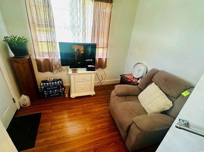 Sitting area featuring finished floors and baseboards | Image 12
