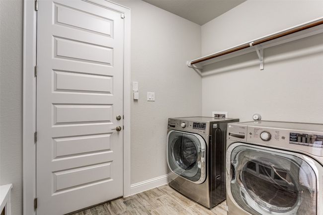 Washroom featuring washing machine and dryer and light wood-style flooring | Image 19