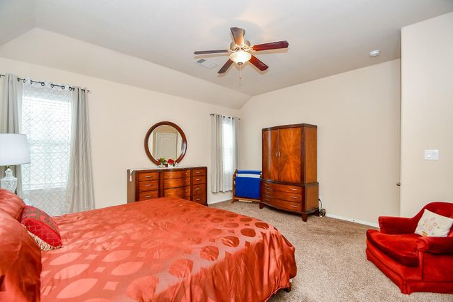 The room features elegant wooden furniture and a warm color palette, creating an inviting atmosphere. | Image 17