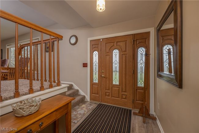 Entryway featuring baseboards, stairs, and wood finished floors | Image 15