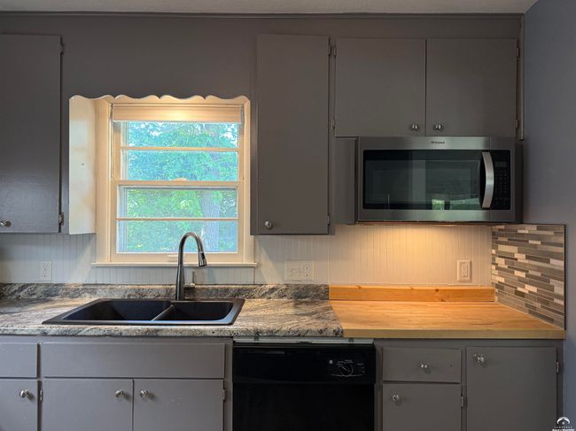 Newer counters & double sink w/ extension wand faucet. Butcher block. Ref, stove, mw, dw, fan. Nice! | Image 15