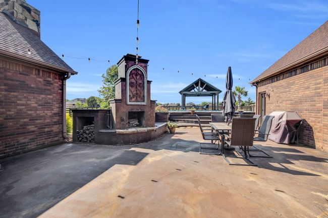 View of patio with exterior fireplace | Image 35
