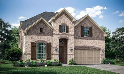 French country style house featuring a garage and a front lawn | Image 1