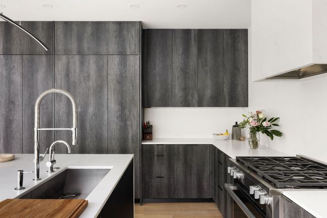 Kitchen featuring stainless steel range with gas cooktop, a sink, modern cabinets, and light countertops | Image 14
