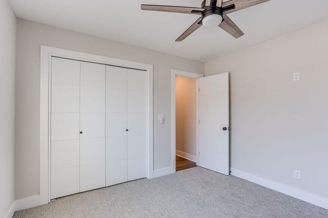 Unfurnished bedroom with carpet flooring, a closet, baseboards, and a ceiling fan | Image 18