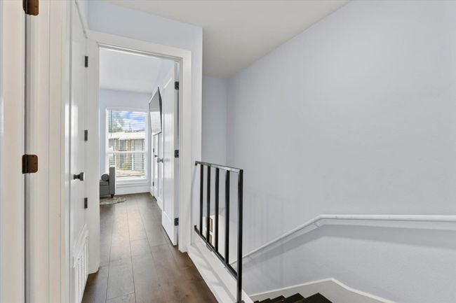 Hallway with an upstairs landing and dark wood-style floors | Image 17