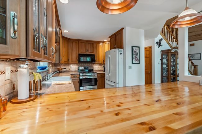 Kitchen with beautiful cabinets and easy flow to dining and living areas | Image 5