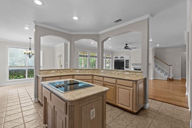 Chef's kitchen featuring stainless appliances, center island, breakfast bar and granite counters | Image 12