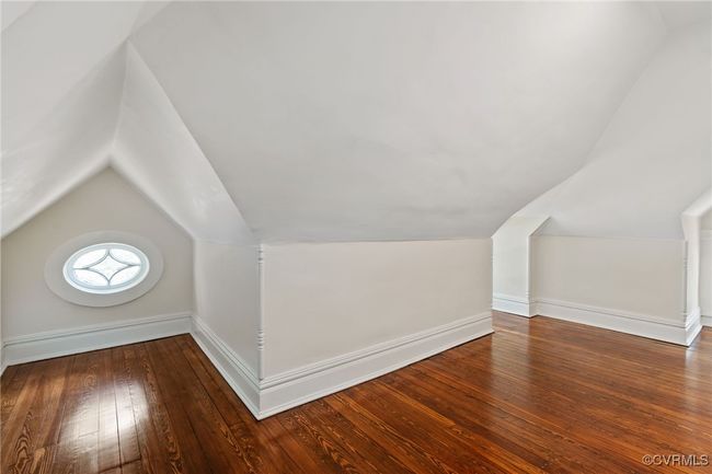 Bedroom featuring baseboards, wood flooring, and lofted ceiling | Image 44