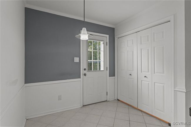 Doorway to outside with ceiling fan and crown molding | Image 11