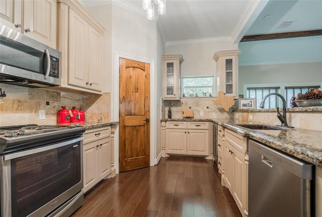 The counter at the end is set up as a bar and the built in wine cooler is to the right. | Image 21
