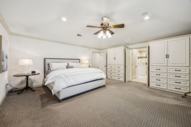 Extensive storage in primary bedroom with built-ins and two walk in closets. | Image 22