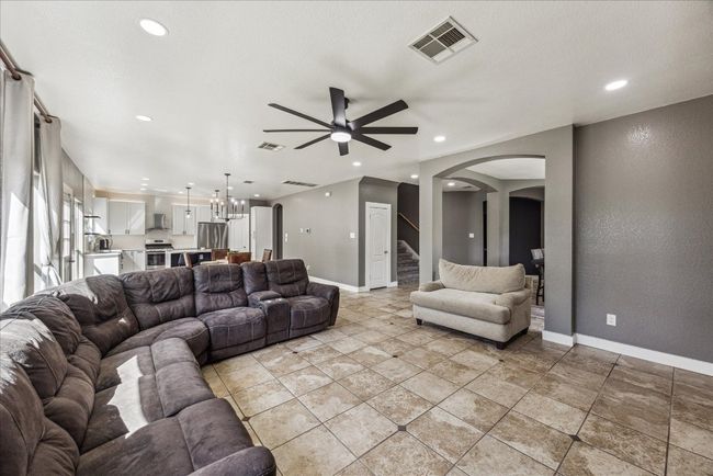 Living area featuring arched walkways, baseboards, visible vents, recessed lighting, and ceiling fan | Image 10