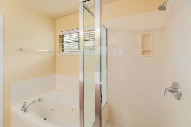 Bathroom with a shower stall and a tub with jets | Image 17