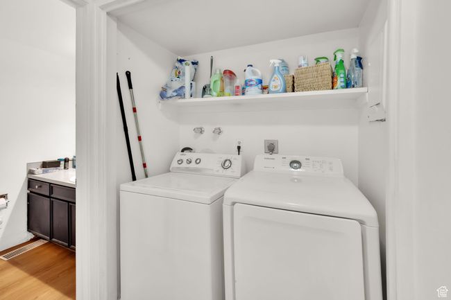Washroom with independent washer and dryer and light wood finished floors | Image 4
