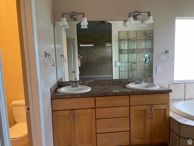 Full bath with double vanity, a bath, and a tile shower | Image 11