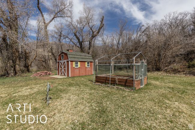 View of yard with a garden, an outbuilding, and a storage shed | Image 50