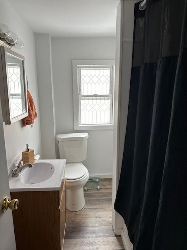 Bathroom with hardwood / wood-style floors, vanity, a healthy amount of sunlight, and toilet | Image 9