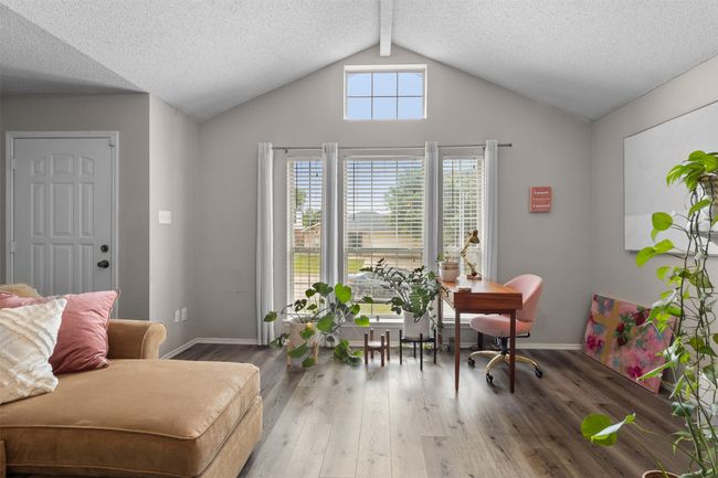 Office space with baseboards, vaulted ceiling, wood finished floors, and a textured ceiling | Image 10