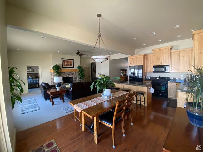 Dining area with dark wood-type flooring and a fireplace | Image 5