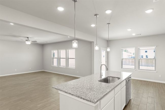 Kitchen with a sink, dishwasher, light wood-style floors, baseboards, and recessed lighting | Image 15