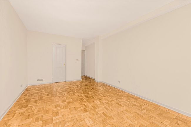 Spare room featuring a baseboard radiator and a wall unit AC | Image 7