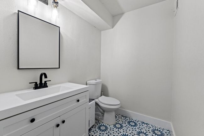 Half bathroom featuring toilet, vanity, and baseboards | Image 23