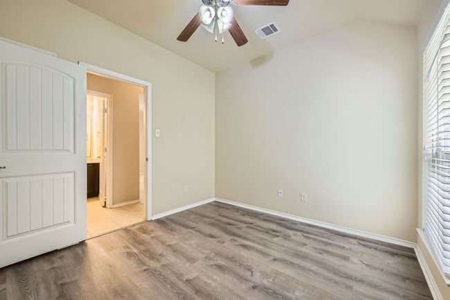 Unfurnished bedroom featuring lofted ceiling, light wood finished floors, and a ceiling fan | Image 20