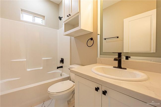 Full bath with marble finish floor, shower / bathing tub combination, vanity, and toilet | Image 21