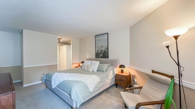 Carpeted bedroom featuring baseboards and a textured ceiling | Image 13