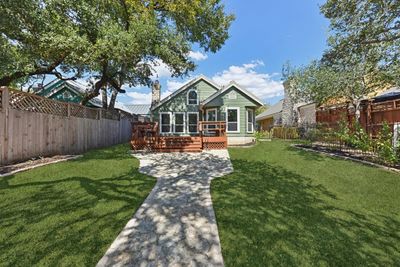 Welcome to this beautiful home with this wonderful backyard! Digitally enhanced to show green grass. | Image 1