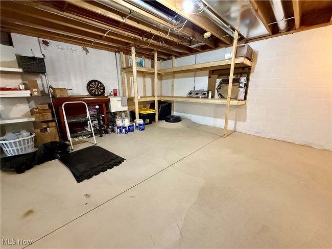 Unfinished below grade area featuring built in storage shelfs, a utility sink, and plumbing is in for another 1/2 bathroom | Image 36