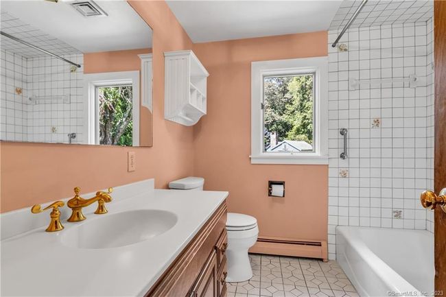 The Hall Bath has shower in tub and attractive ceramic tile tub surround. | Image 21