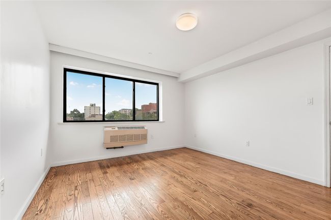 Spare room featuring wood-type flooring and a wall mounted air conditioner | Image 26