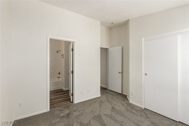 Unfurnished bedroom featuring carpet flooring, connected bathroom, and baseboards | Image 17