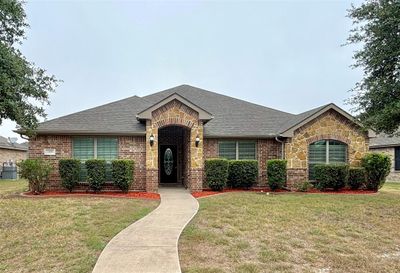 Ranch-style home with a front lawn and nice shrubs | Image 1