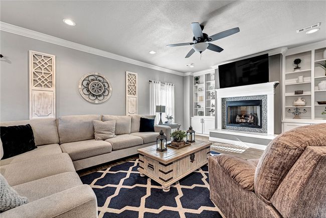 Living room showcasing the built-ins and gas log fireplace. | Image 14