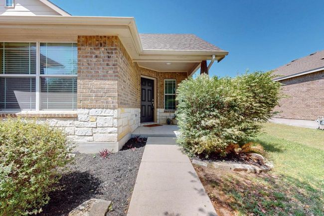 Nicely landscaped area at front of home. | Image 23