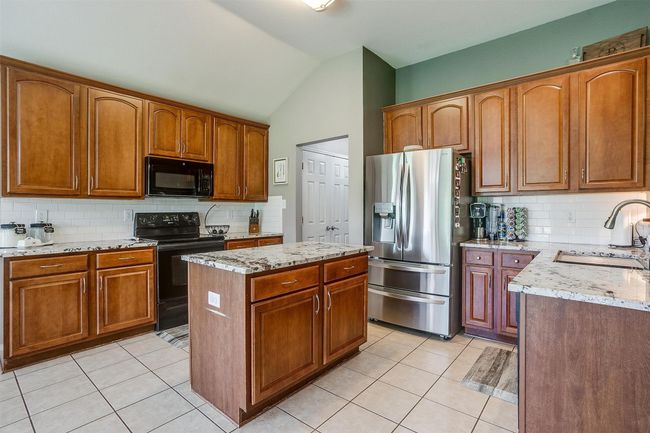Kitchen with island. | Image 18