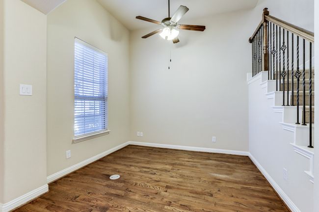 Empty room featuring a ceiling fan and wood finished floors | Image 5