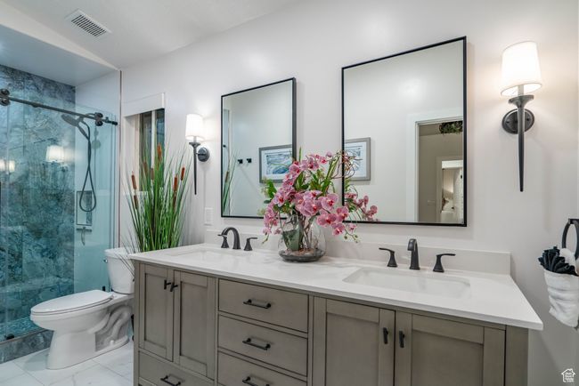 Bathroom with toilet, a shower with door, and vanity | Image 8