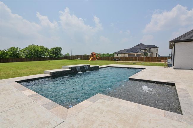 View of pool with pool water feature, a playground, and a yard | Image 30