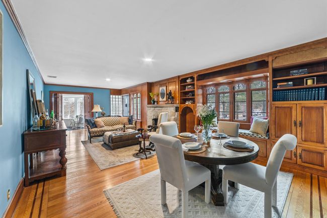 Living room/Dining room featuring hardwood / wood-style floors, a fireplace, and ornamental molding | Image 5